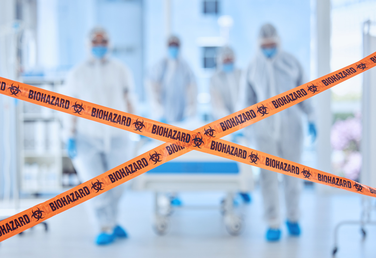 Hazmat-suited cleaning team entering a biohazard zone behind warning tape in a controlled environment